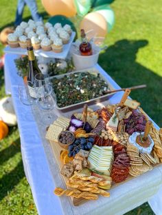 a table topped with lots of different types of food and drinks on top of it