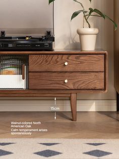 a record player sitting on top of a wooden dresser