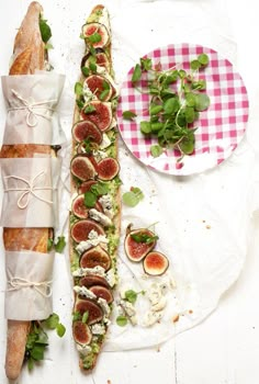 an assortment of food is displayed on plates and napkins, along with breadsticks