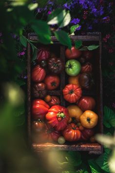 a wooden box filled with lots of different types of vegetables