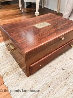 a wooden box sitting on top of a rug