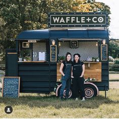 two women standing in front of a food truck that sells waffles and co