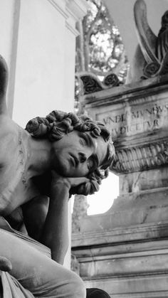 black and white photograph of a statue of a man with his head in his hands