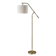 a floor lamp with a white shade on the base and a gold metal frame,