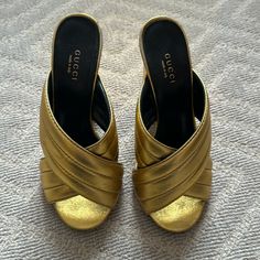 Gucci Gold Webby Cross Over Sandals. Please Note Condition In Photos. Size 37. Heel Is 4.25. Luxury Gold Mules With Block Heel, Designer Mules With 4-inch Heel, Designer Gold Sandals With Heel Loop, Luxury Closed Toe Mules With 4-inch Heel, Luxury 4-inch Heel Closed Toe Mules, Luxury Mules With 4-inch Heel And Round Toe, Designer Gold Sandals With Round Toe, Designer Gold Sandals With Wrapped Heel, Luxury Mules With Wrapped Heel And Round Toe