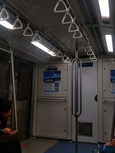 the inside of a subway car with people sitting on it