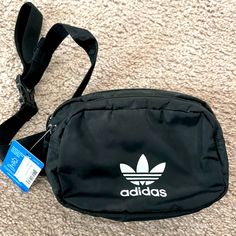 Adidas Fanny Pack New With Tags Across Your Body Or Around Your Waist, Any Way You Style It, This Adidas Waist Pack Is The Perfect Size. Zip Pockets Provide Easy Access To Your Essentials And Keep Your Small Stuff Organized Multiple Zip Pockets Adjustable Waist Strap Adjusts Up To 58 Inches Hidden Zip Pocket Interior Earbud And Charger Storage Color: Black Crossbody Fanny Pack Adidas, Adidas Casual Bags For Outdoor Activities, Casual Adidas Bags For Outdoor Activities, Adidas Bags With Adjustable Strap For Outdoor Activities, Adidas Bag With Adjustable Strap For Outdoor Activities, Casual Adidas Shoulder Bag For Travel, Trendy Adidas Black Bag, Trendy Black Adidas Bag, Casual Adidas Bags For Everyday Use