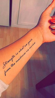 a woman's arm with a quote on it