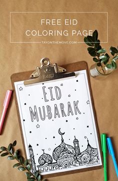 a clipboard with the words eid mubarak on it next to markers and pencils