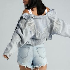 Layer On This Rocker-Chic Denim Jacket For A Glam Festival Vibe! It Features A Collared Neckline, Long Sleeves With Buttons To Cuff, A Complete Button-Down Front, Front Pockets, Rhinestone Fringe Detailing Down The Front And Back, And A Cropped, Relaxed Fit. The Sparkling Rhinestone Fringe Will Move With You As You Dance To The Music. Style With Sleek Hoop Earrings And Cowboy Boots. Fit & Features Collared Neckline Long Sleeves, Button Details Button-Down Front, Dual Front Pockets Rhinestone Fri Festival Denim Fringe Outerwear, Festival Long Sleeve Outerwear With Frayed Hem, Denim Outerwear With Frayed Hem For Festival, Spring Festival Outerwear With Frayed Hem, Festival Denim Jacket With Frayed Hem, Frayed Hem Denim Jacket For Festivals, Long Sleeve Denim Jacket With Frayed Hem For Festival, Casual Spring Outerwear For Rodeo, Spring Rodeo Denim Jacket With Pockets