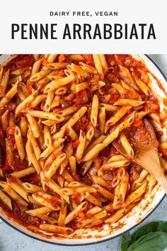 a pan filled with pasta and sauce on top of a table