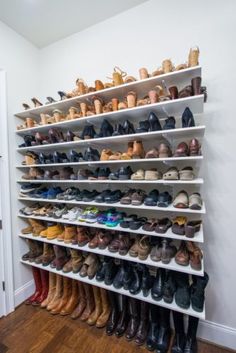 a white shoe rack filled with lots of shoes