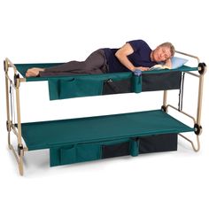 a man laying on top of a bunk bed next to two bins with handles