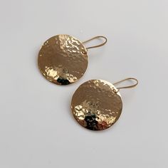 "Small (25mm) round hammered and domed gold plated statement earrings finished with an elegant gold plated ear wire.  Disc is approximately 25mm in diameter. Please note the display bust is not full size so the earrings look bigger than they would in real life Free postage for UK customers These earrings come with a branded gift box Also available in a larger (40mm / 1\") diameter https://www.etsy.com/uk/listing/1360968121/big-domed-hammered-gold-earrings-40mm?click_key=b494347d2aba3026afddbc6e1f2819bbced824bc%3A1360968121&click_sum=6d050272&ref=shop_home_active_1&frs=1&sts=1" Hammered Gold Plated Jewelry, Minimalist Round Earrings For Summer, Nickel-free Round Summer Jewelry, Hand Forged Gold Round Disc Jewelry, Hammered Recycled Gold Drop Earrings, Hammered Metal Round Earrings, Hammered Round Disc Metal Jewelry, Hammered Metal Round Disc Jewelry, Hammered Brass Drop Earrings