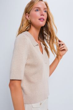 On-trend and elegant as ever, the Tan Henry Polo is an elevated basic that deserves a spot in your closet. Crafted from a smooth, slightly textured luxe knit, this must-have top combines effortless style and comfort with its relaxed yet cropped fit and classic polo collar. Pair it with jeans and sneakers for an everyday casual look, wear it with tailored trousers and ballets for work, or style it with skirt and heels for a cute date night 'fit. Collared V-neck Short sleeve Ribbed cuffs and hem R Cashmere Tops With Ribbed Neckline For Work, Chic Ribbed Neckline Knit Top For Work, Everyday Knit Top With Ribbed Neckline, Solid Color Ribbed Cashmere Tops, Collared Fine Knit Top For Spring, Ribbed Cashmere Tops, Knit Tops With Collared Neckline For Fall, Spring Fine Knit Collared Top, V-neck Knit Top With Ribbed Collar For Workwear