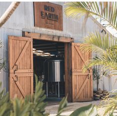 the entrance to red earth brewing is made out of wood and has an open door