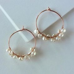 Pretty pearls and trendy rose gold are the perfect partners in these bohemian beauties!  Handwrapped from genuine freshwater pearls and rose gold-filled wire. Earrings measure 1 inch/2.5 cm across.  Giving as a gift? Gift wrap available here: Rose Gold Pearl Jewelry With Wire Wrapped Detail, Wire Wrapped Rose Gold Hoop Jewelry, Rose Gold Wire Wrapped Hoop Jewelry, Rose Gold Wire Wrapped Hoop Earrings, Rose Gold Dangle Hoop Earrings With Pearl Drop, Elegant Rose Gold Copper Wire Jewelry, Elegant Rose Gold Earrings With Copper Wire, Earring Inspo, Pearl Hoop Earrings