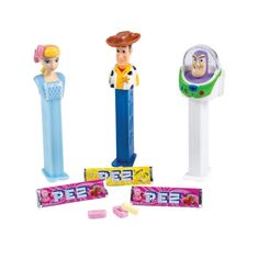 three toy figurines are shown with candy bars and candies in front of them