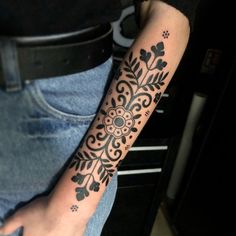 a person with a black and white tattoo on their arm