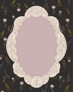 an ornate frame with flowers and leaves on a black background