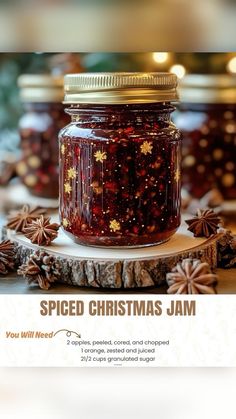 a jar filled with christmas jam sitting on top of a wooden table next to pine cones