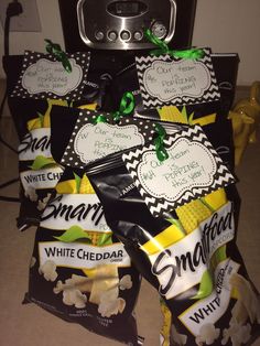 bags of white cheddar popcorn sitting on the floor next to an electric stove