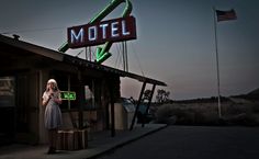 a woman standing in front of a motel