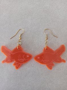 Laser engraved and laser cut orange goldfish earrings with gold plated hardware.  Rubber earring backs included.  Drop length is 2 inches, width across front is 1 5/8, and acrylic thickness is 3mm.  Very light on the ears. Goldfish Earrings, Cut Orange, Engraved Earrings, Goldfish, Earring Backs, Laser Engraved, Laser Engraving, Bend, Jewelry Earrings Dangle