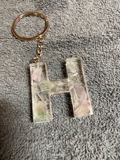 the letter h is made out of ice and has a keychain attached to it