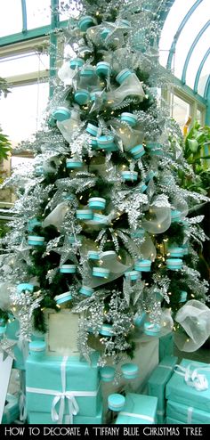 a christmas tree decorated with blue and silver presents