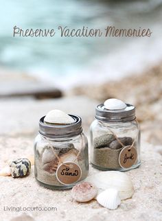 two glass jars filled with sand and shells