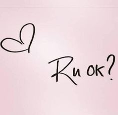 the word ru ok written in cursive writing on a pink paper