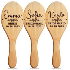 three wooden paddles with the names of bridesmaid and groomsmid on them