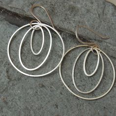 A new eye-catcher - long earrings. Earrings made of 925 silver wire and metal rings in different sizes - the outer ring is 30 mm. - Versatile earrings, also nice as a gift. The earrings have a total length of approx. 4.5 cm. I bent the ear hooks out of 925 silver wire, cold forged and filed them. The earrings come with silicone stoppers to avoid losing them. All my offers are designed in small editions or as individual pieces by me and lovingly and carefully handcrafted - Blickfang2. - More from Modern Wire Wrapped Hoop Earrings For Gift, Sterling Silver Open Circle Earrings In Silver, Handmade Elegant Hoop Earrings, Silver Open Circle Earrings For Gift, Silver Open Circle Earrings For Pierced Ears, Handmade Modern Open Circle Earrings, Elegant Handmade Open Circle Hoop Earrings, Modern Handmade Open Circle Earrings, Wire Wrapped Sterling Silver Hoop Earrings