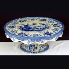 a blue and white cake plate on a table