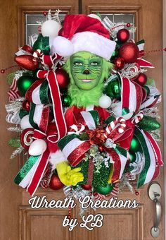 a christmas wreath with an elf's face and candy canes on the front door