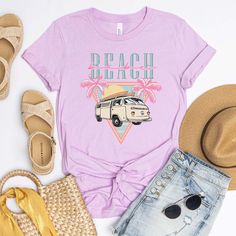 Ditch the dull and show off your wild side with our "Beach Babe Van" tee! This retro-inspired piece is just the thing to show off your cool, laid-back style with its throwback van and groovy palm tree graphics. Let's hit the beach! Size Guide: we recommend your true size for a loose fit or size down for a fitted fit. Tees are Unisex. Heather blend shirts are 52/48 Cotton/ Poly Blend and Shirts are Unisex. CREW NECK SIZING: Small - Length, 28" Width, 18" (4/6) Medium - Length, 29", Width, 20" (8/ Tropical Graphic Print T-shirt For Beach, Casual Beach T-shirt For Warm Weather, Bohemian Short Sleeve Beach T-shirt, Summer Cotton T-shirt With Palm Tree Print, Summer Cotton T-shirt For Beach Party, Bohemian Crew Neck T-shirt For Summer, Tropical Relaxed Fit T-shirt For Beach Season, Cotton T-shirt For Summer Vacation, Relaxed Fit Summer T-shirt For Beach Party