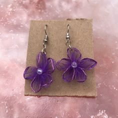 Lightweight, small size, purple flower earrings!  🌈 Handmade 🌈 🌸 Fabric flower with a bead center! 🌸 💗 Customization available! 💗 Message me if you have any questions and we can work on making your idea come to life! Processing time for orders is 3-5 business days If you need it sooner message me and we can upgrade you to Priority shipping (1-3 business days) or give you an estimated processing time! Elegant Purple Flower Earrings, Elegant Purple Flower Shaped Earrings, Purple Flower Earrings With Ear Wire For Gift, Purple Flower Earrings With Ear Wire As Gift, Lavender Flower-shaped Earrings For Gifts, Handmade Purple Dangle Earrings, Adjustable Purple Flower Earrings As Gift, Adjustable Purple Flower Earrings For Gift, Purple Flower Earrings With 3d Flowers As A Gift