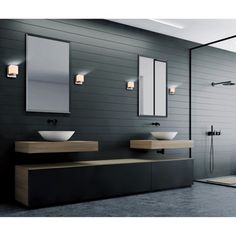 a bathroom with two sinks and mirrors on the wall, along with a walk in shower