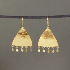 A stunning and unique pair statement Moroccan style drop earrings are handmade in a rustic Moroccan style in 18ct gold plated sterling silver. These lovely earrings have a distinctly Moorish feel to them. Softly beaten and smoothed and given a subtle matte finish that glistens subtly as it catches the light, these eye-catching earrings are accentuated, each with five beaten discs that hang from the bottom and move with the wearer. Each earring has an overall drop of approximately 5cm and is hand Gold Hand Forged Dangle Chandelier Earrings, Gold Hand Forged Chandelier Earrings As Gift, Hand Forged Gold Chandelier Dangle Earrings, Gold Hand Forged Chandelier Drop Earrings, Artisan Long Drop Gold Jewelry, Artisan Yellow Gold Hammered Earrings, Artisan Hammered Drop Earrings, Artisan Hammered Yellow Gold Earrings, Gold Hand Forged Drop Earrings