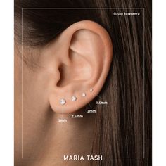 an ear piercing with three small diamonds on it