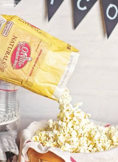 a bag of popcorn being poured into a basket