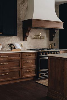 a kitchen with an oven, range and counter tops in it's center island