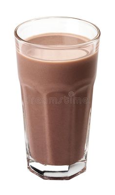 a glass filled with chocolate milkshake on top of a white background royalty images