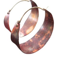 These sweet, petite hoops make great "every day" earrings. They are hammered, flame patinated copper. The color on the copper is due to the Flame-patina, which is a spontaneous process and allows for an array of red/orange colors patterns, no two are exactly alike. Sterling ear wire fits into hole in back of hoop to close. Medium - 1 1/2" diameter Artisan Bronze Copper Hoop Earrings, Unique Small Hoop Copper Earrings, Hand-forged Copper Earrings In Rust Color, Hand Forged Rust-colored Unique Earrings, Red Orange Color, Ear Wire, Wholesale Jewelry, Color Patterns, Patina