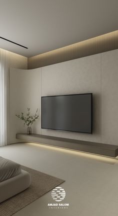 an empty living room with a large flat screen tv on the wall and white curtains