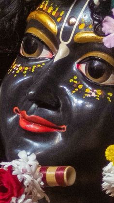 a close up of a mask with flowers on it's face and nose,