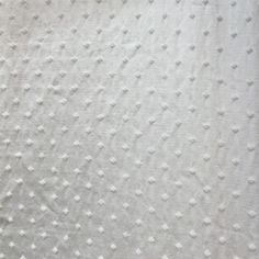 a white blanket with small dots on it