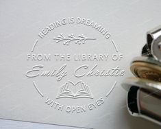 a close up of a stamp on a piece of paper next to a fountain pen