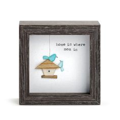 a wooden frame with a bird hanging from it's side and the words home is where mom is